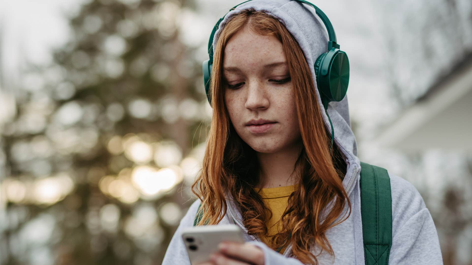 gen z woman who knows taking space is a healthy response looking at her phone