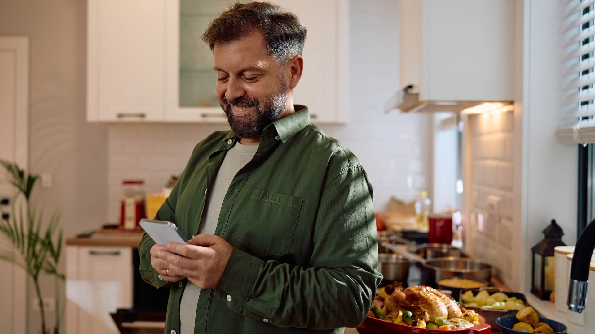 man using his phone to look up a recipe