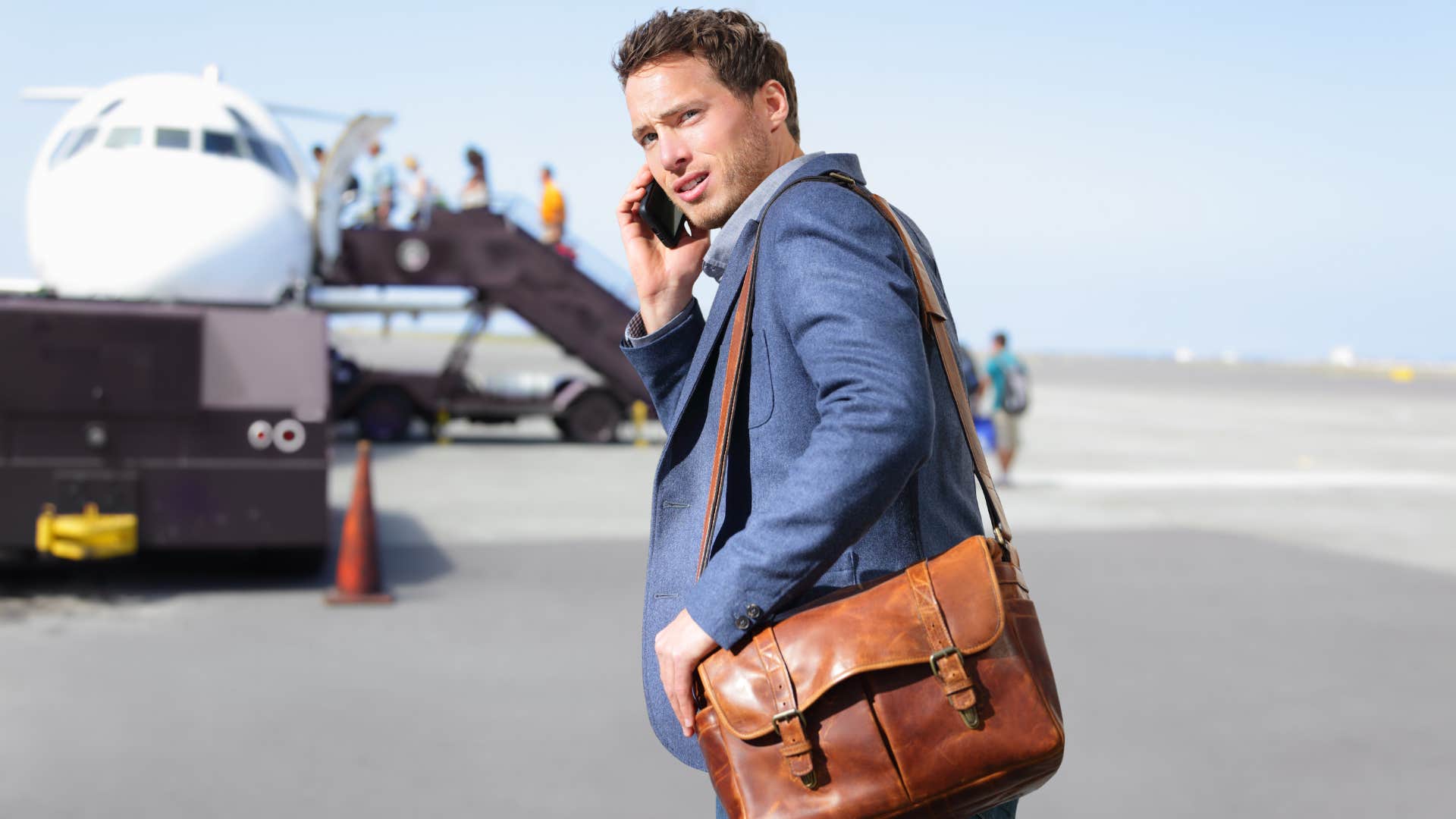 man feeling anxious while answering his phone