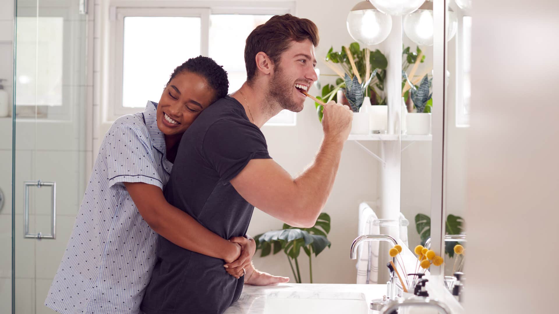 happy couple helping each other get ready before 9 AM