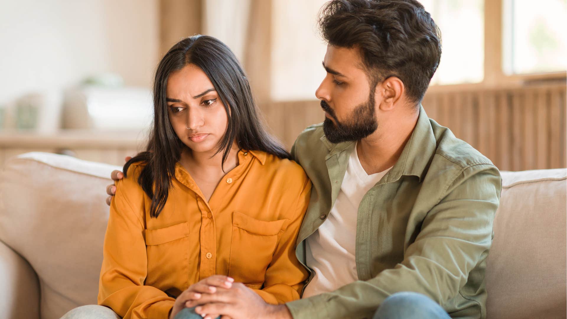 woman talking to a man that is trying to come up with excuses
