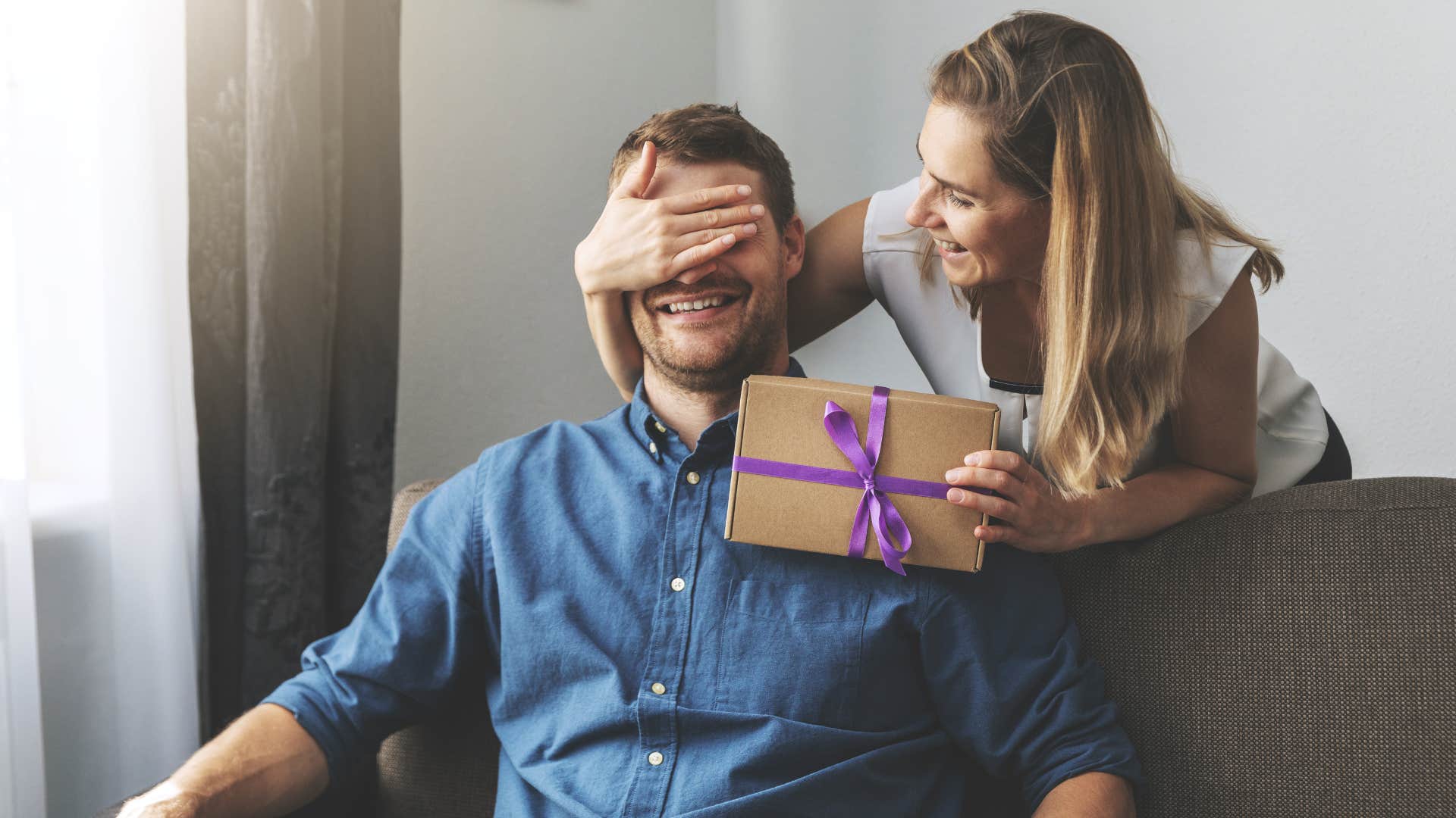 wife surprising husband with gift