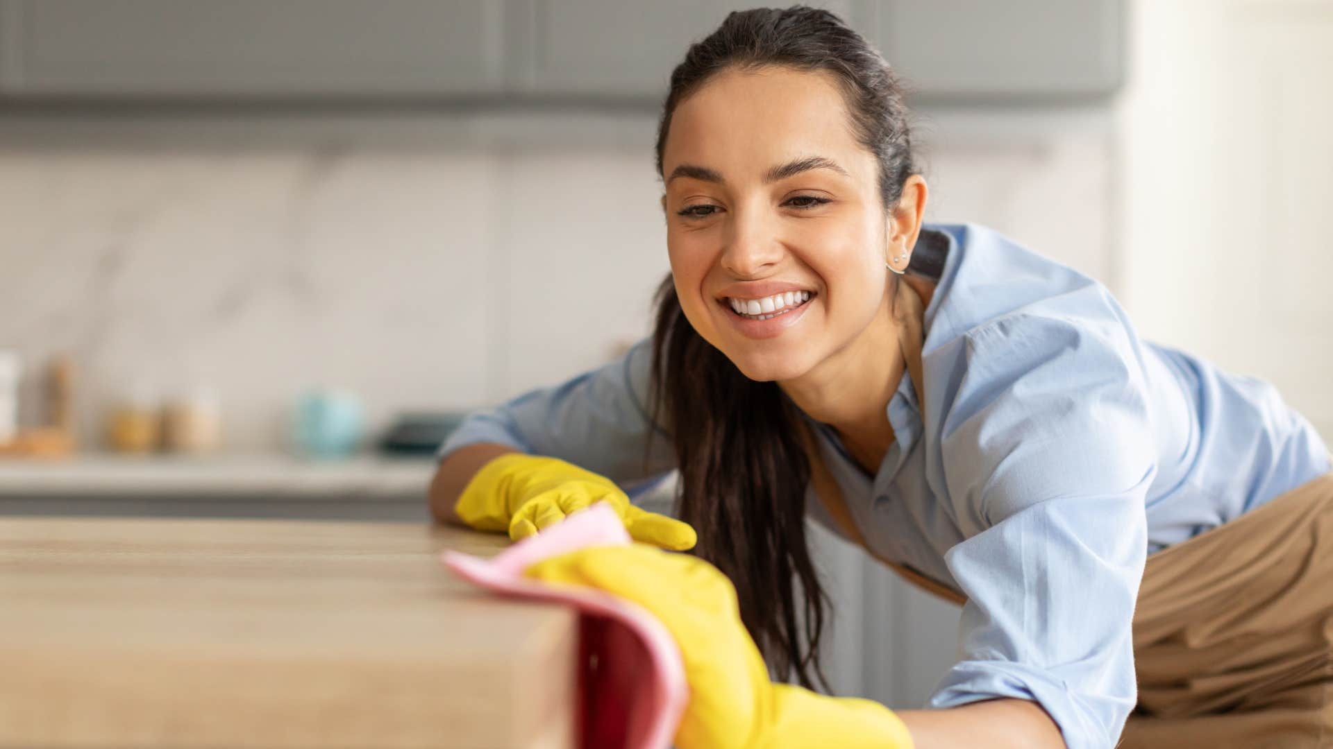 woman cleaning the dusty corners of her home