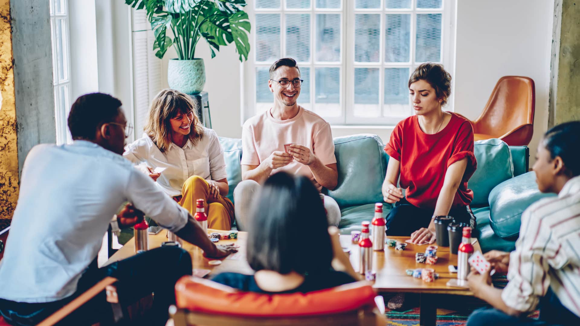 Host sits with guests in comfortable home