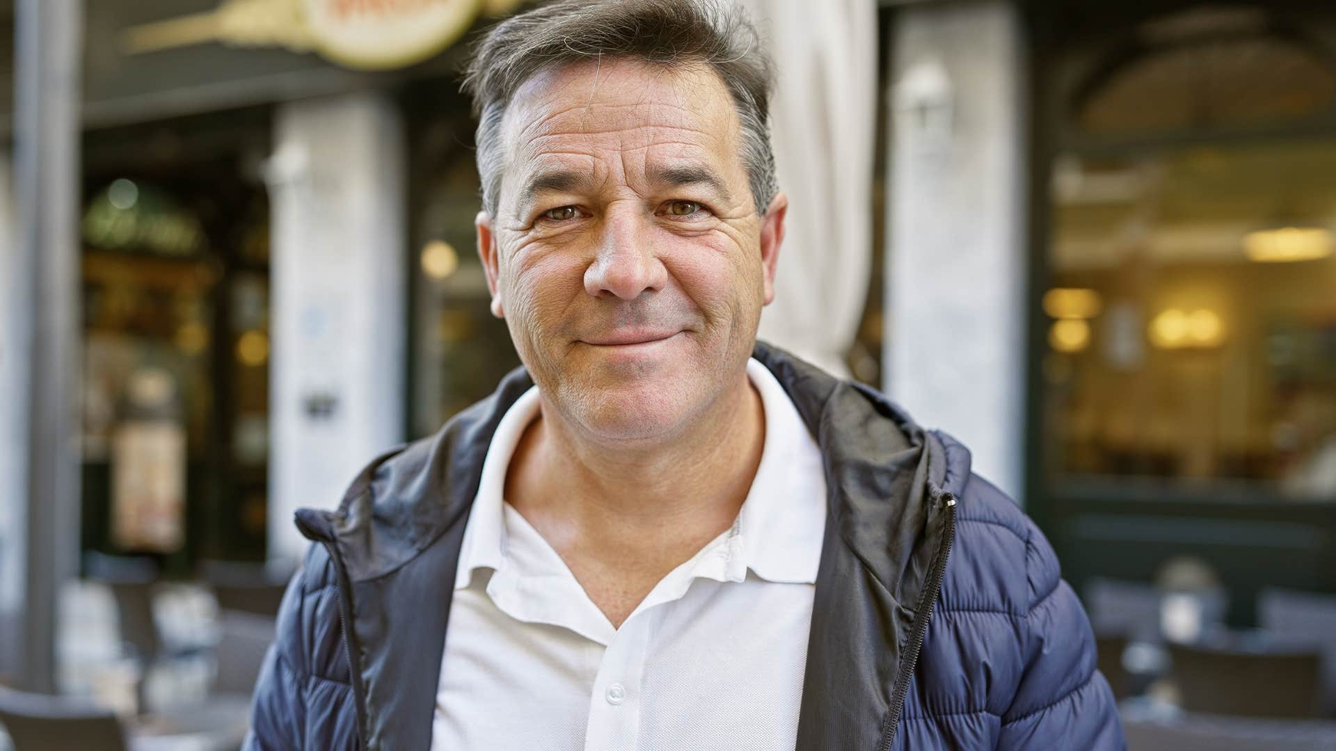 Man who's not the societally acceptable version of "masculine" smiling.