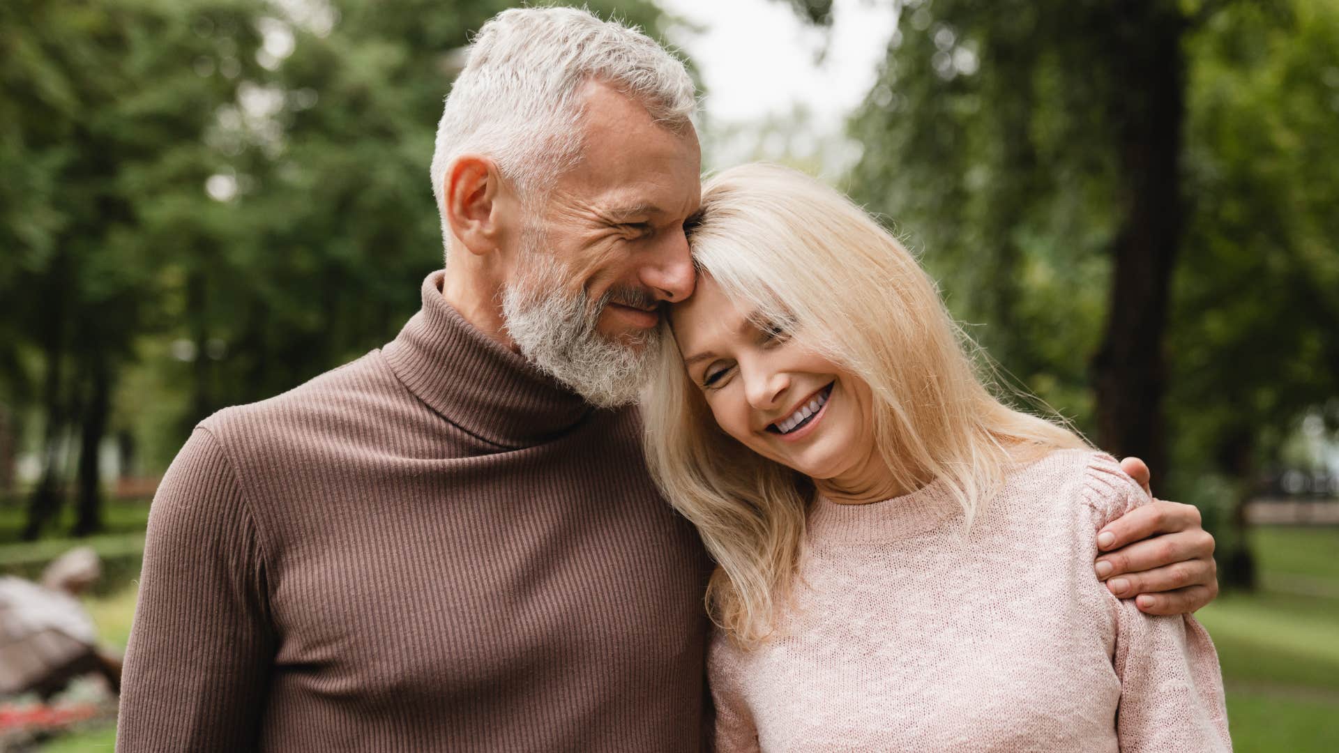 Man who doesn't care about being the protector all of the time hugging his wife.