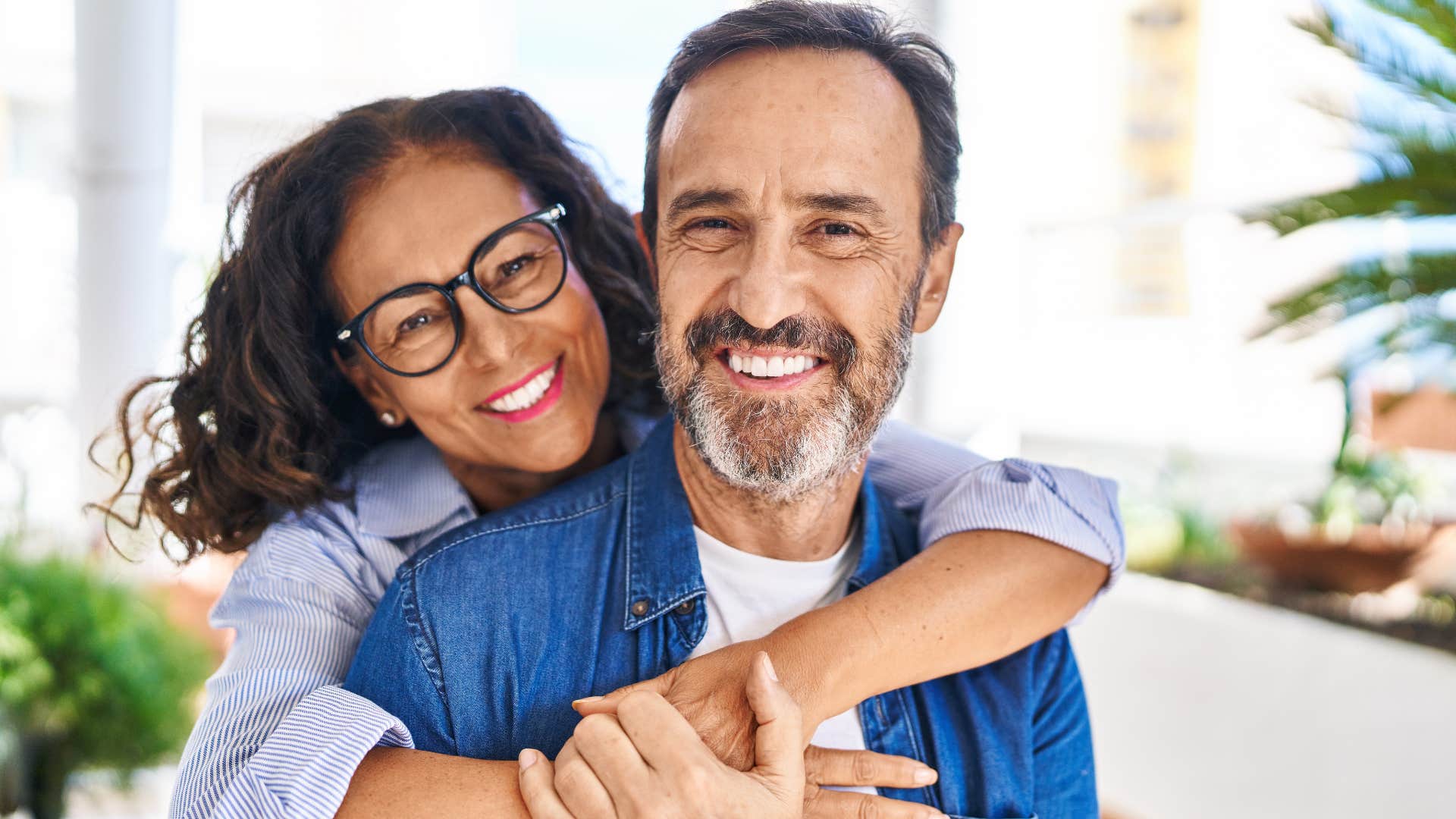 Man who doesn't care about chasing potential partners smiling with his wife.