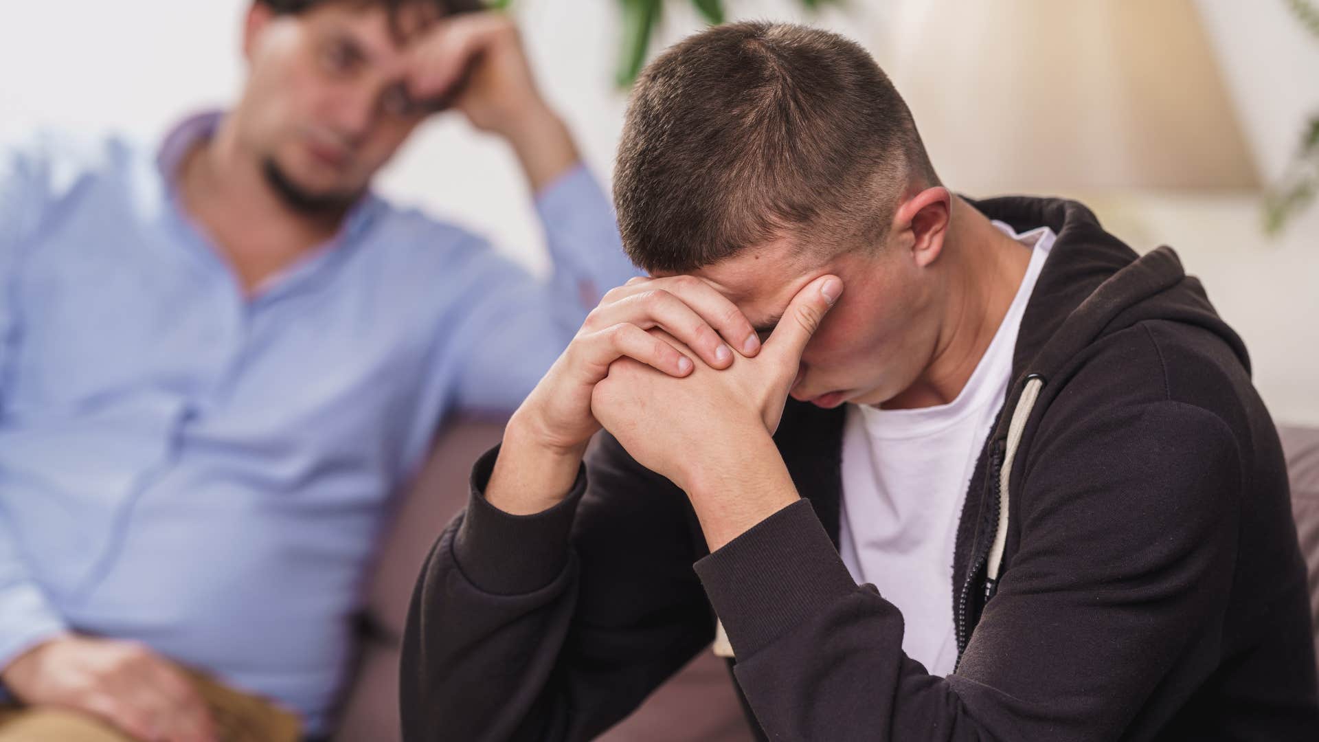 Man saying "when I was your age" to his upset adult son.