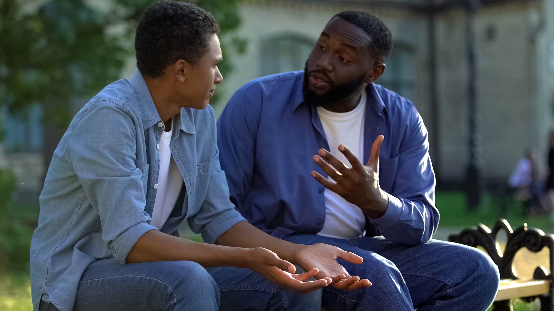 Man saying "Why do you never visit?" to his adult son.