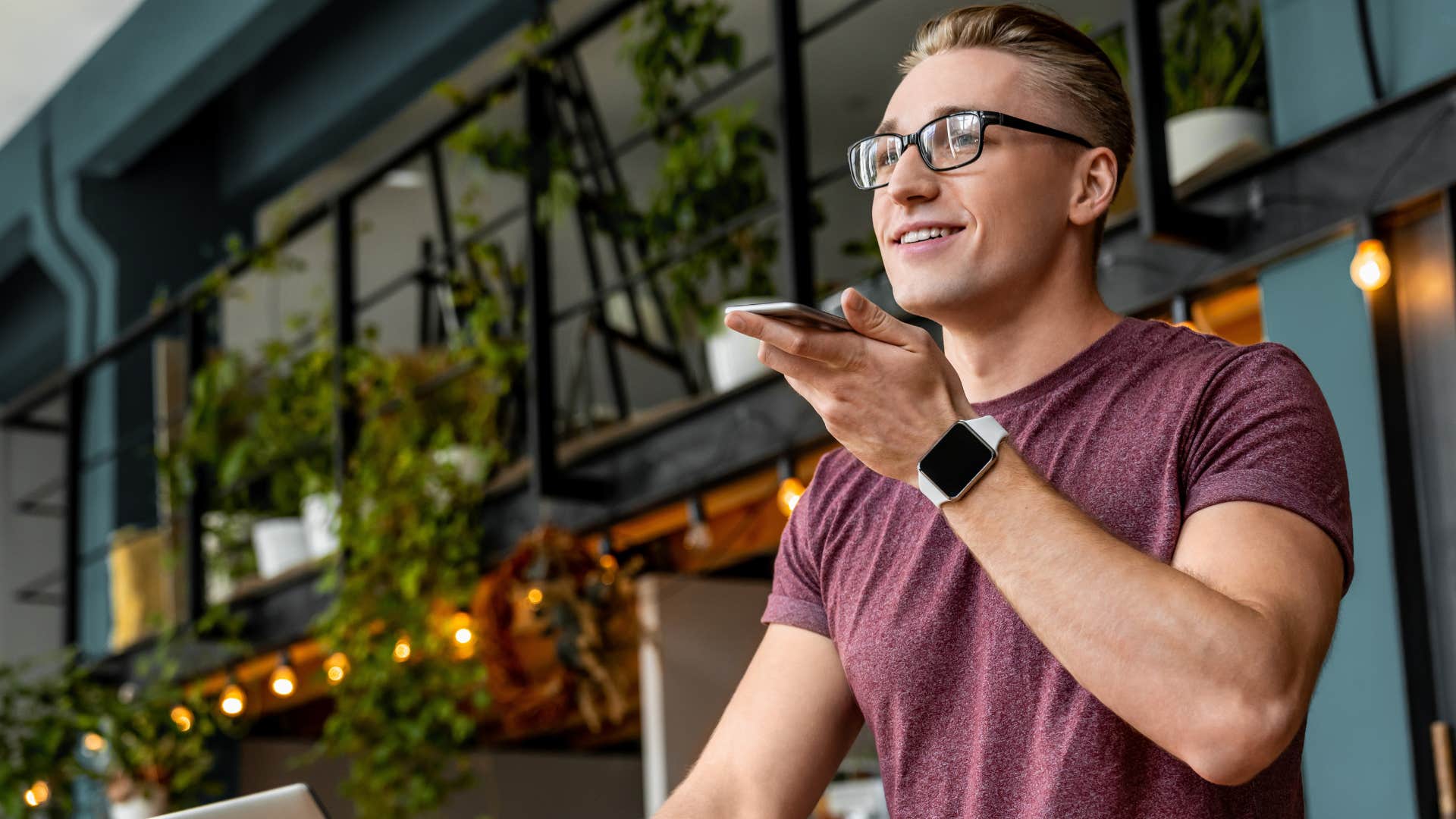 man talking on the phone at home surrounding by overly expensive decor