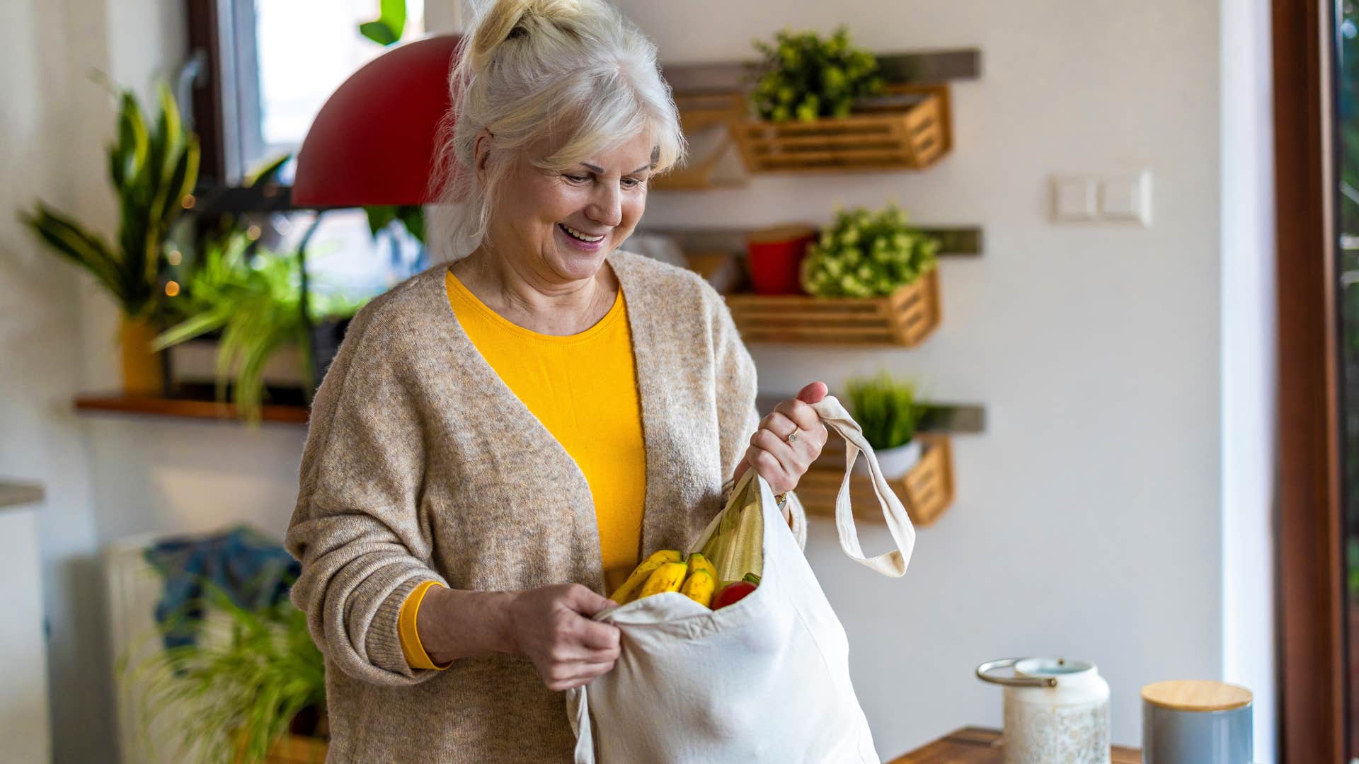 wealthy woman smiling and unloading fresh produce