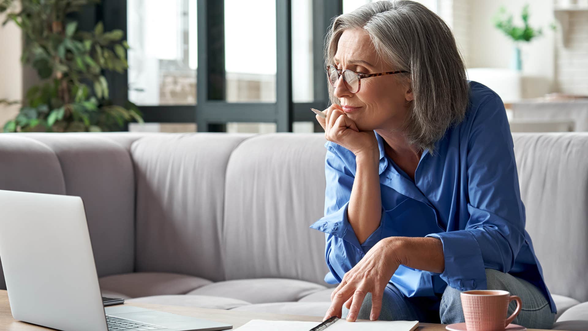 wealthy woman working in silence on her couch