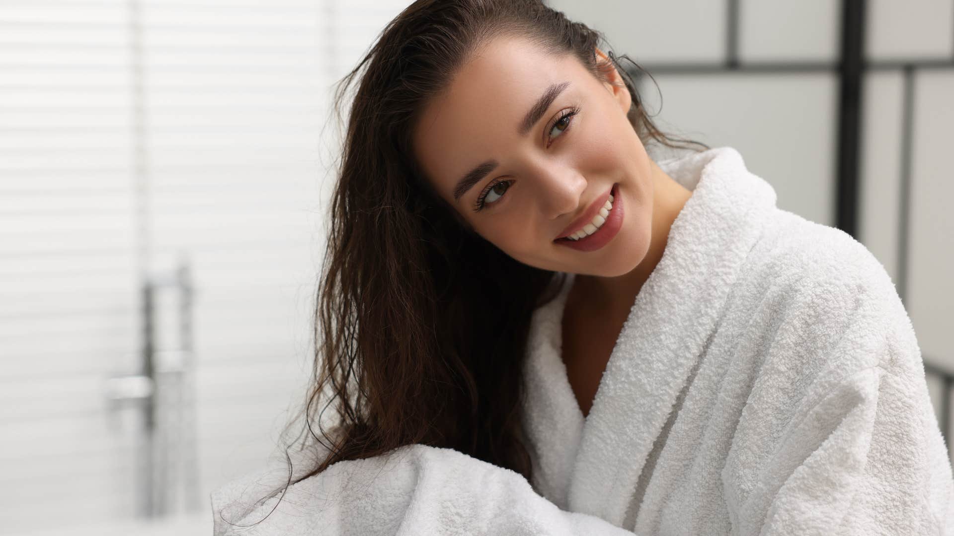 woman drying her hair with matching towels