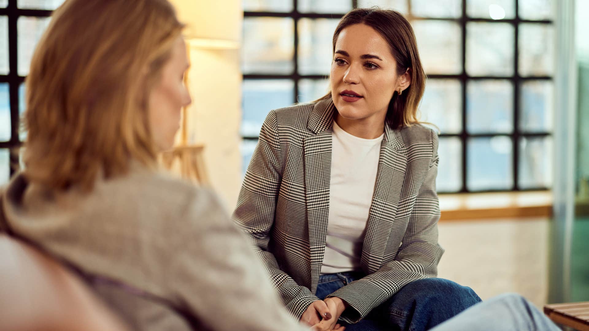 Woman who can call out misbehavior talking to a co-worker.