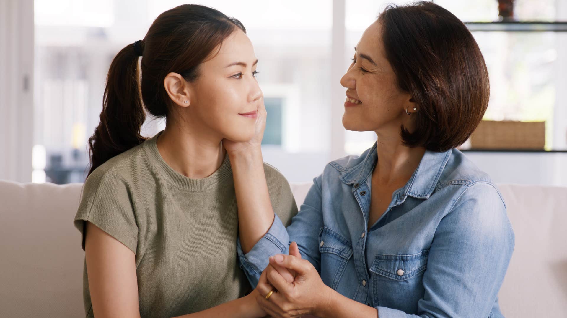 Woman who's calm during conflict comforting her adult daughter.