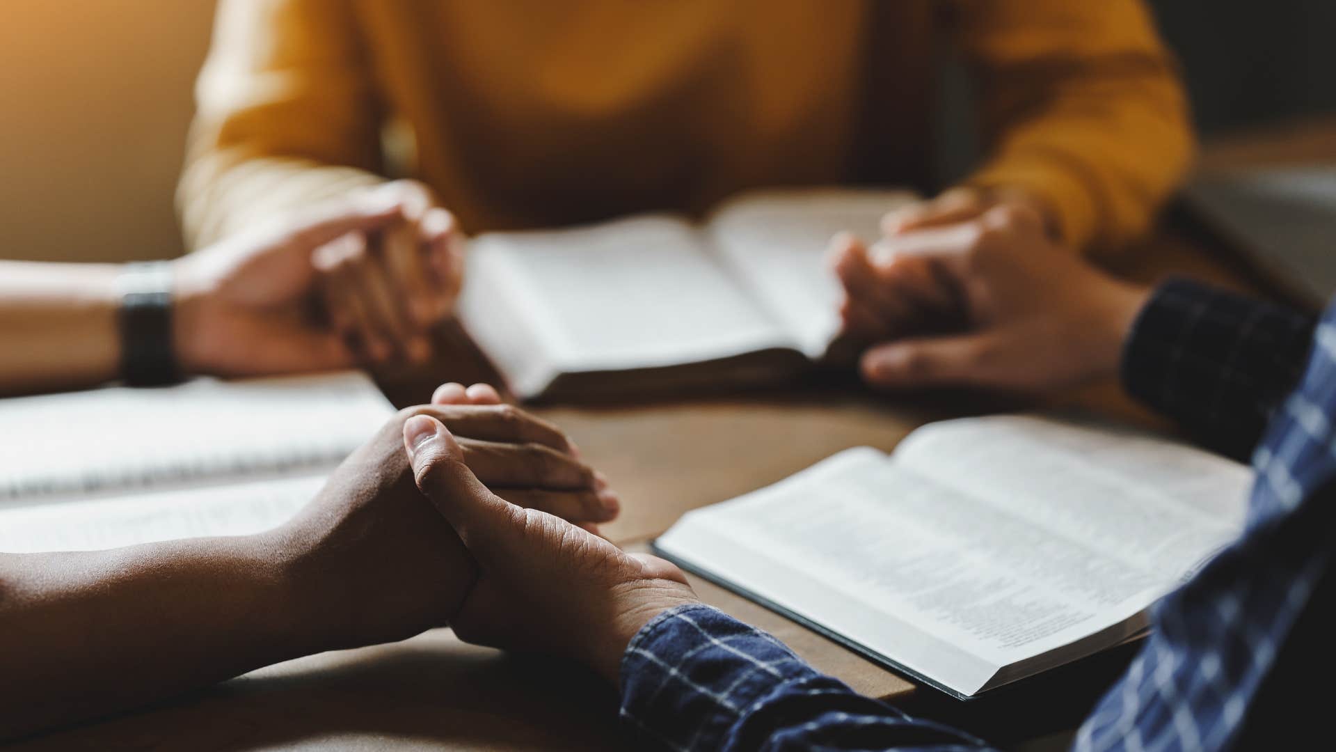 southern family reading scripture and holding hands