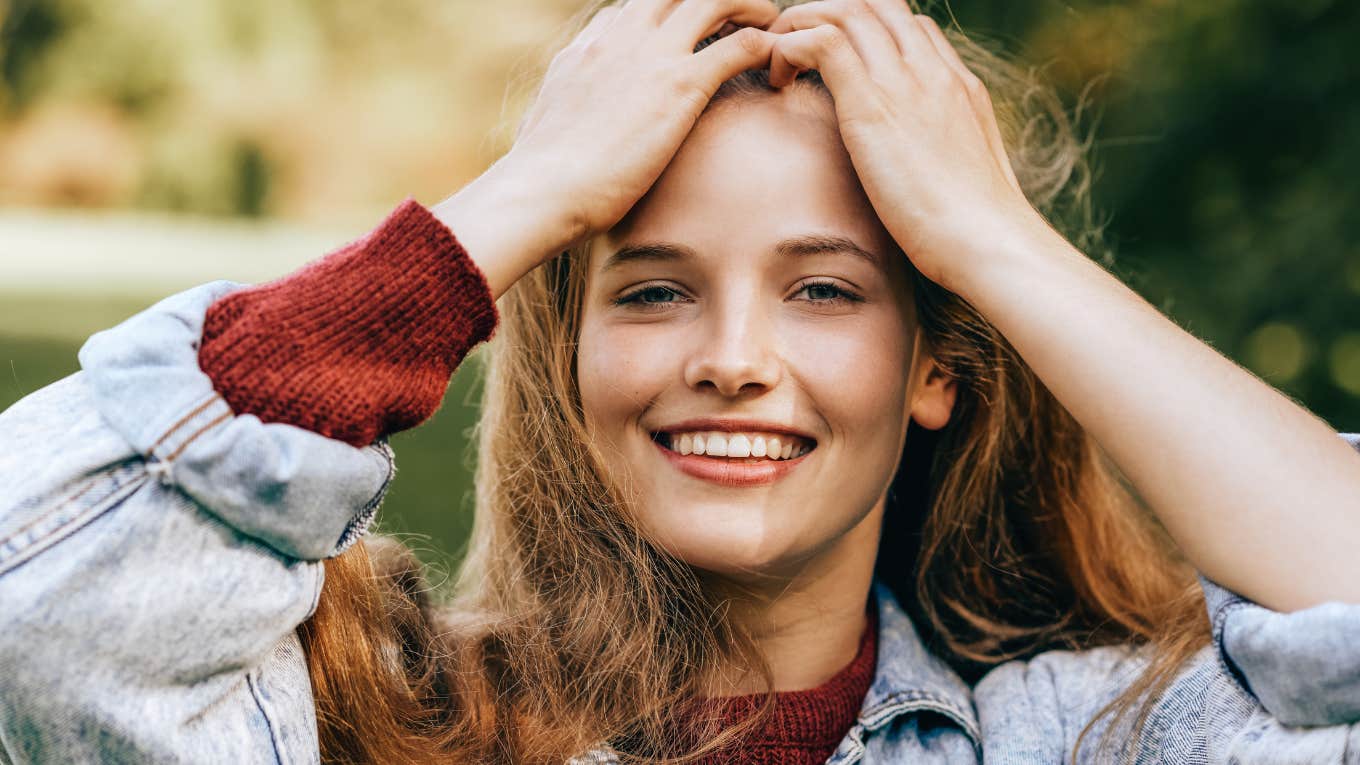 Things People Raised By Southern Parents Do That Everyone Else Thinks Is Weird young smiling woman pushing her hair back