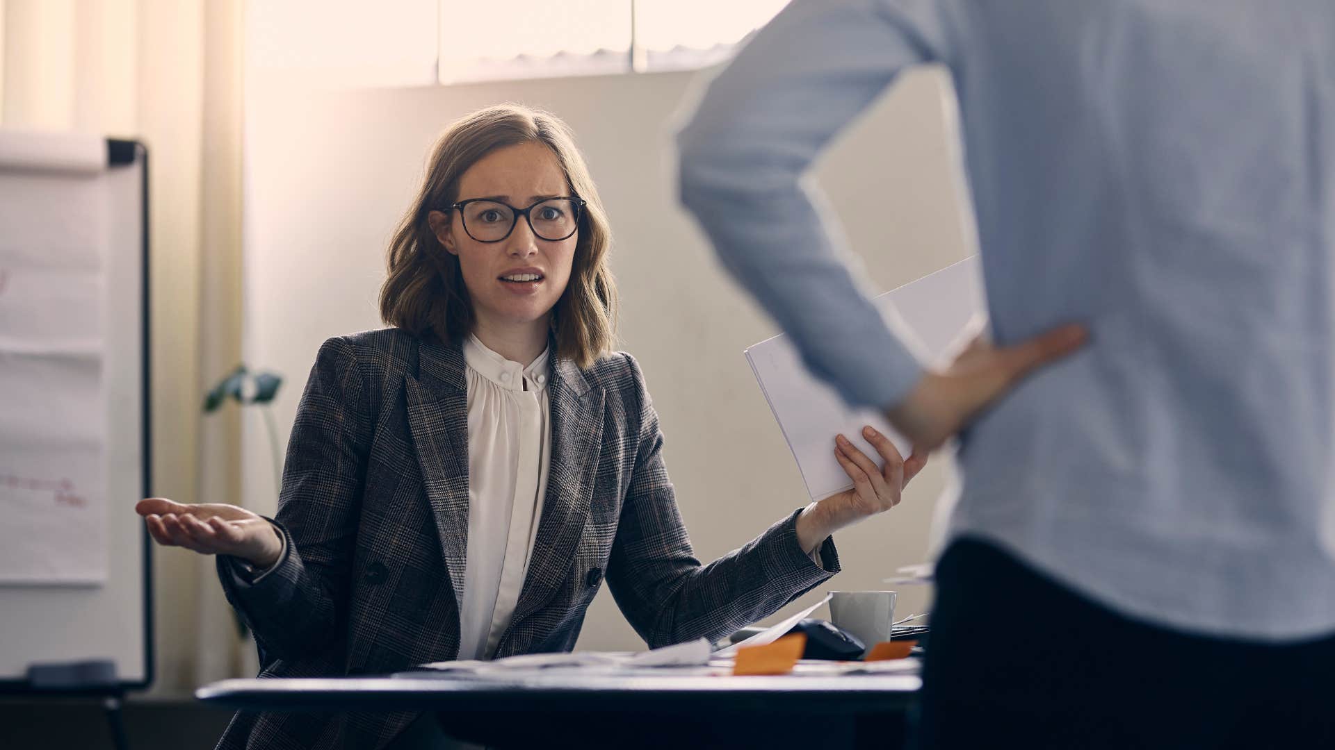 entitled woman telling colleague this is beneath her
