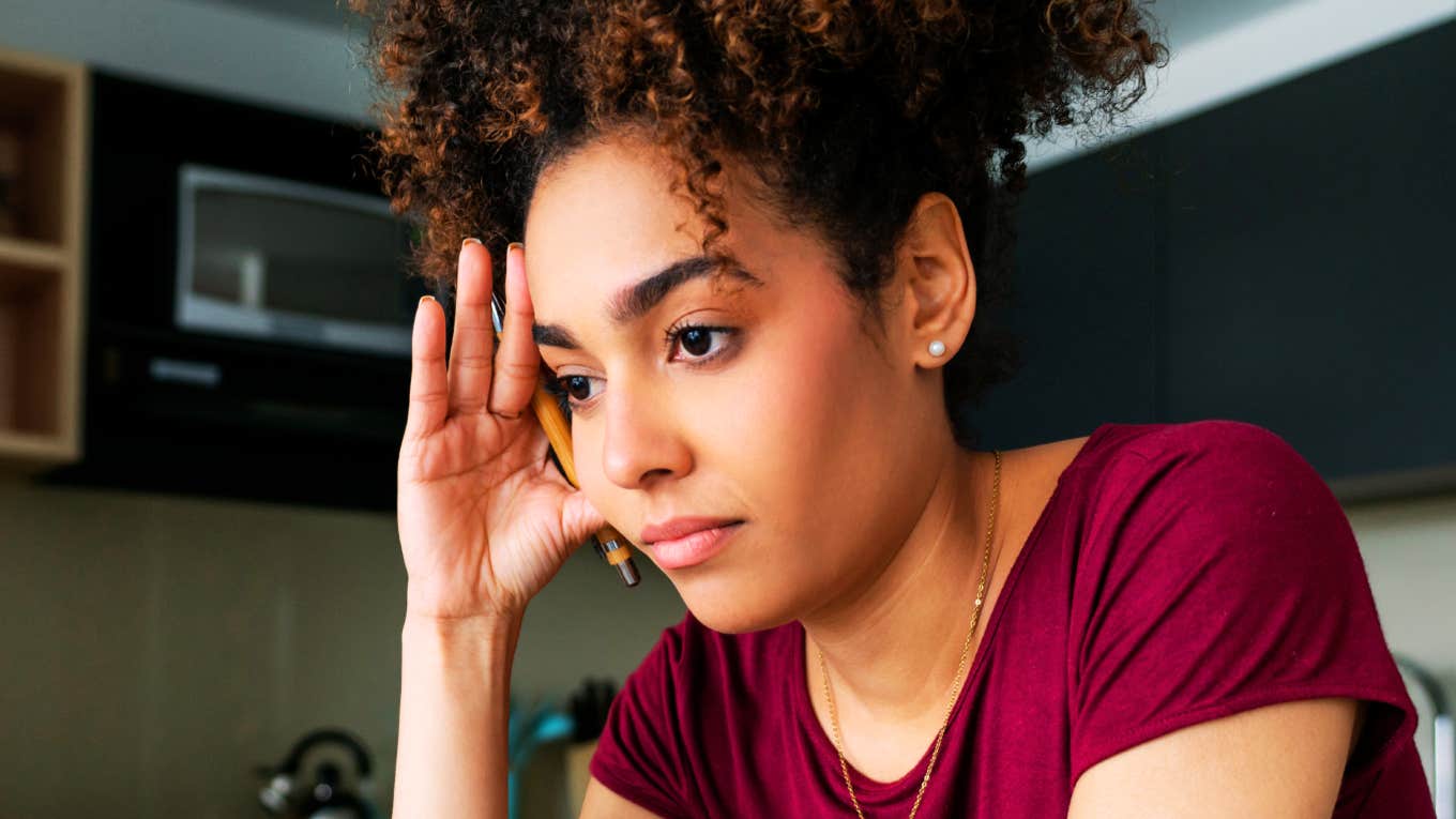Things You Probably Still Struggle With If You Grew Up In An Unsafe Family, According To Experts Woman struggling as a adult after growing up in a unsafe family.