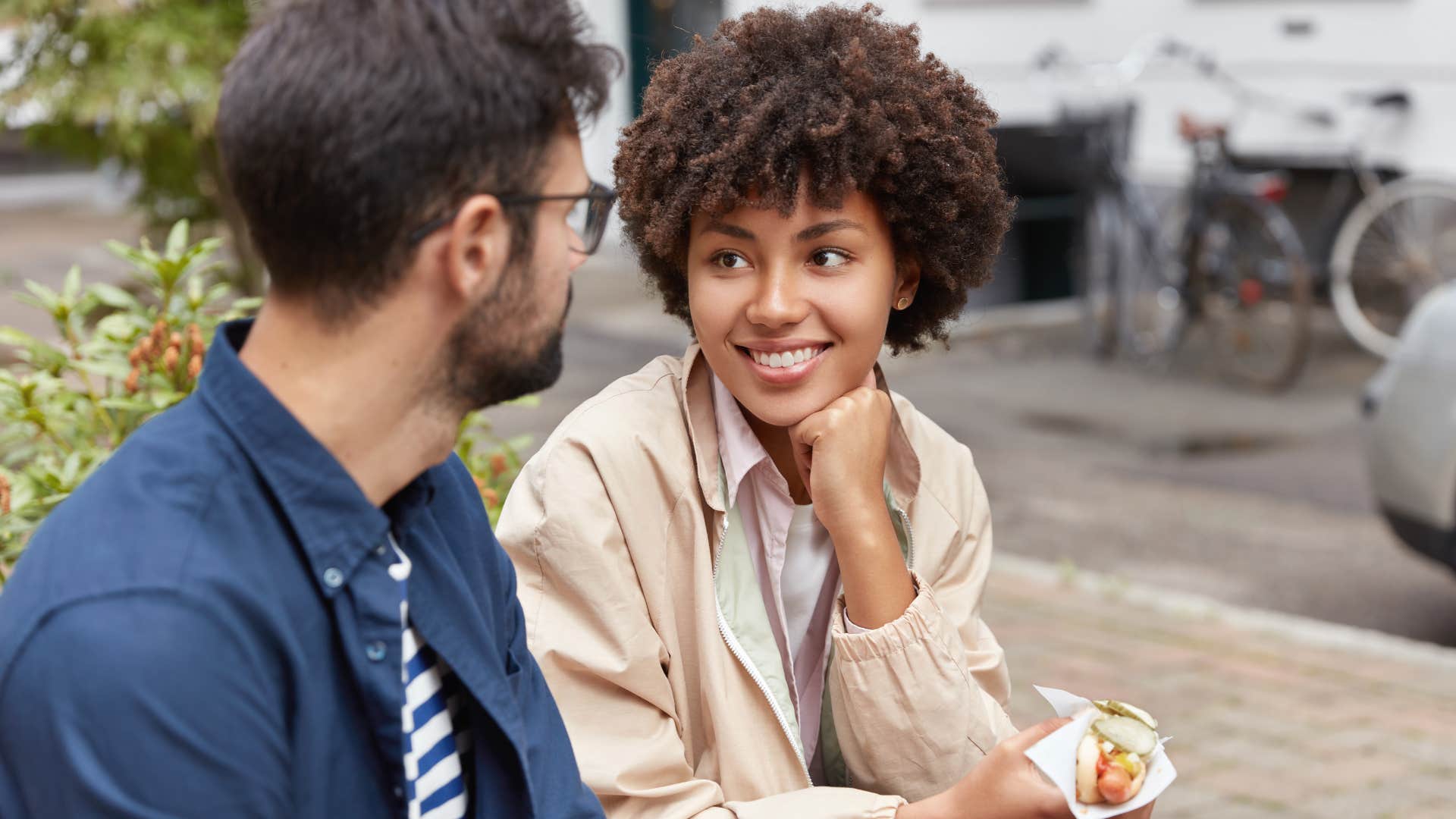 Woman assuming everyone has good intentions and smiling at a man.