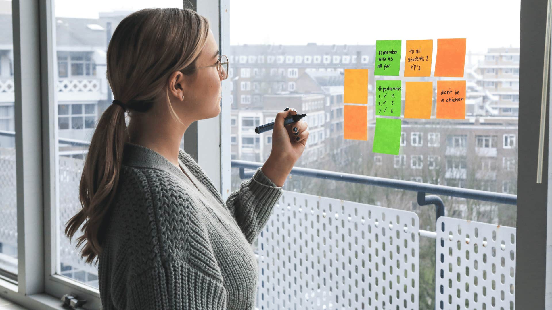 woman using sticky notes to brainstorm