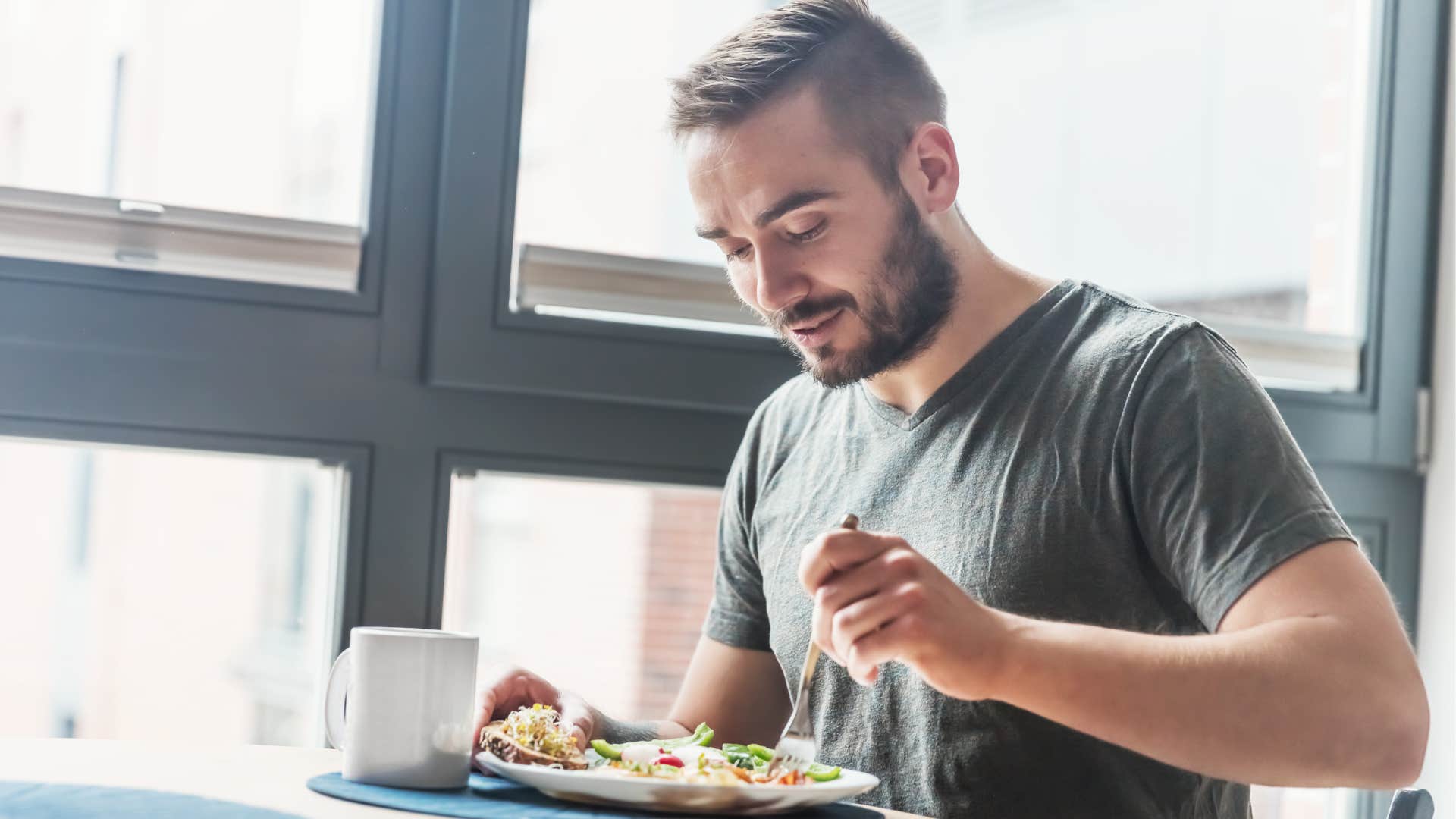 man eating food at buffet in public