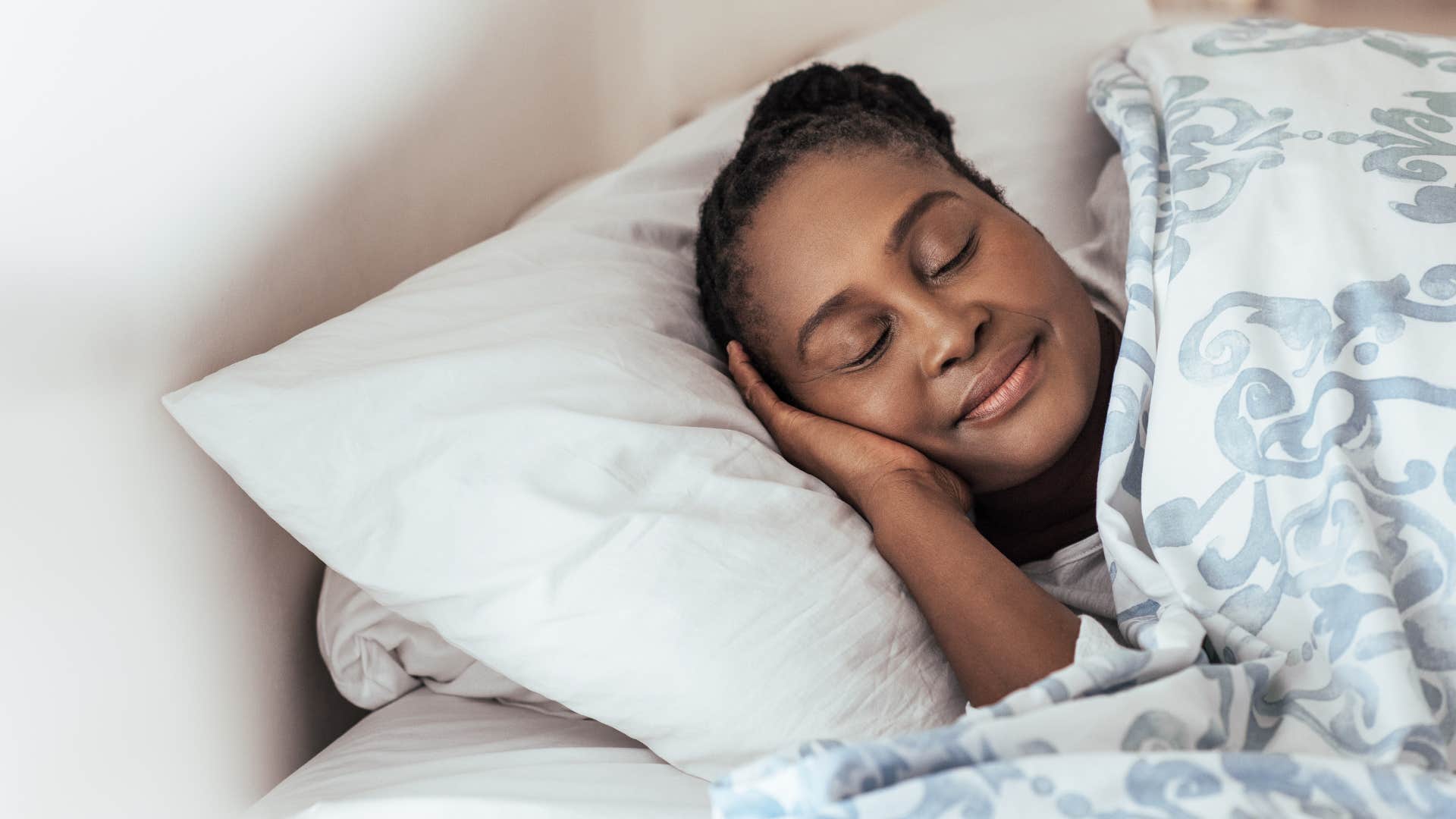 woman wearing her outside clothes in bed sleeping peacefully