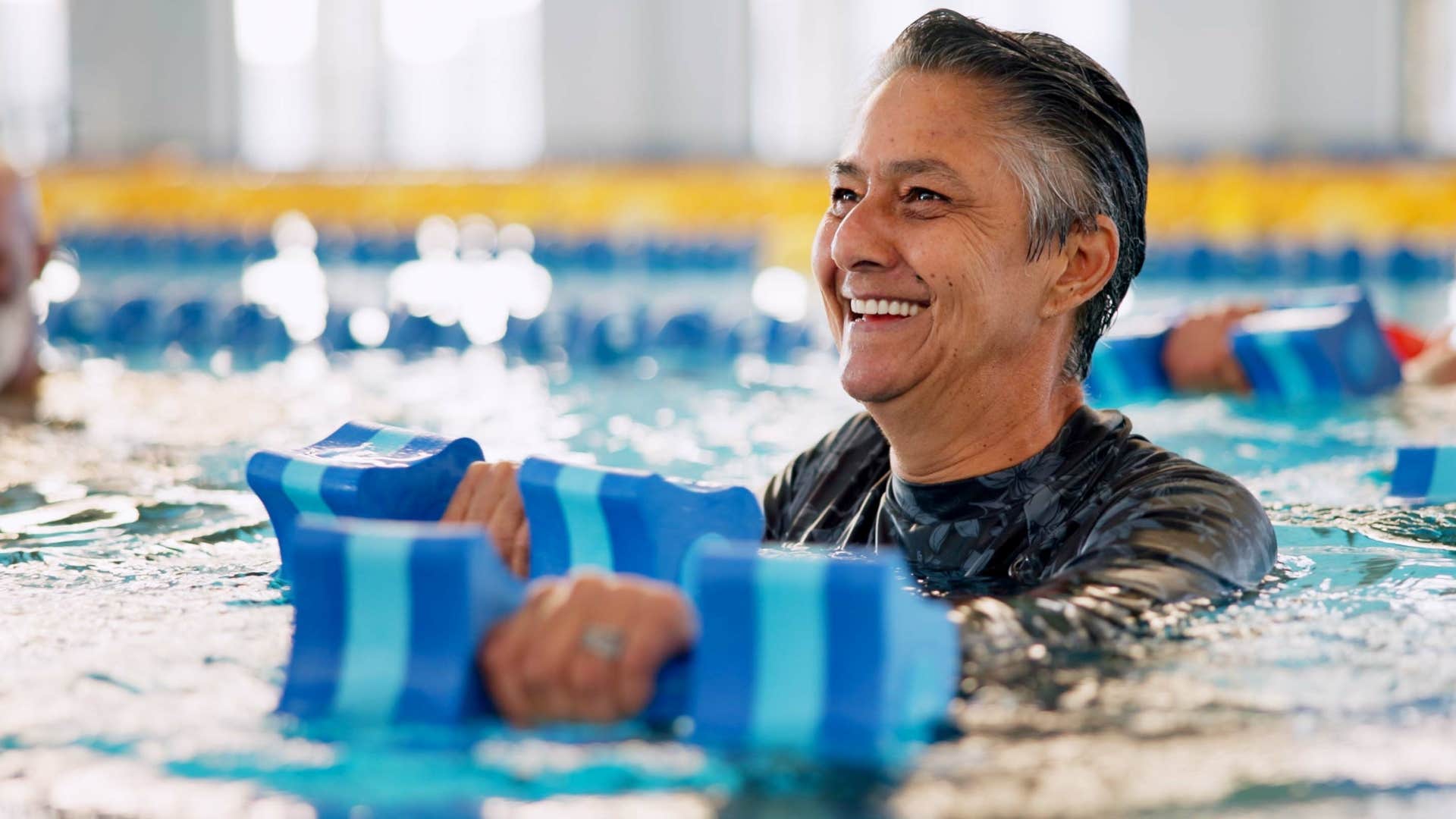 older woman swimming in public pool