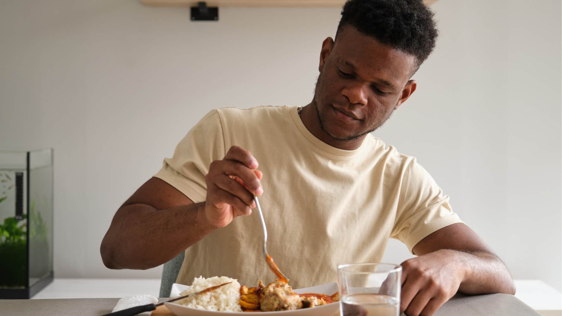 Man eating before going out at home.