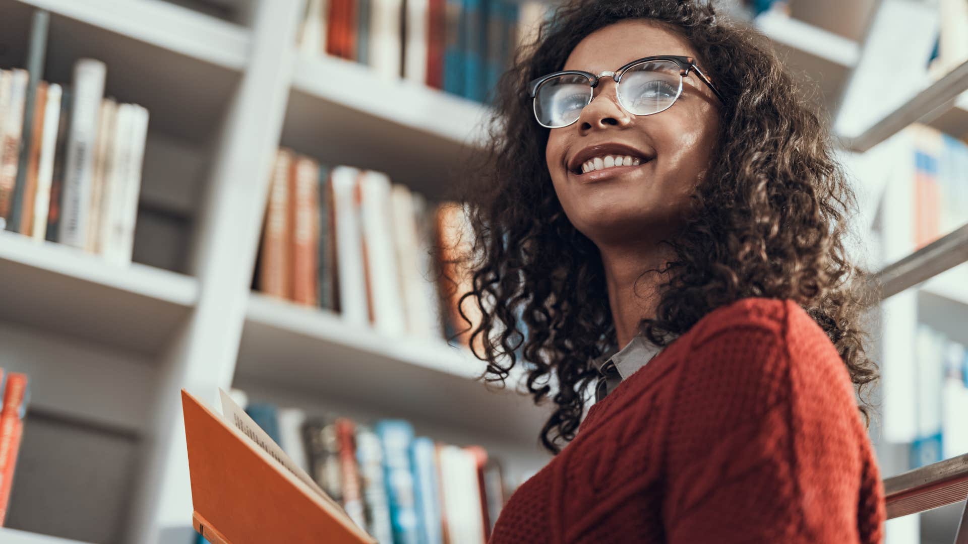 Woman smiling and using the library.