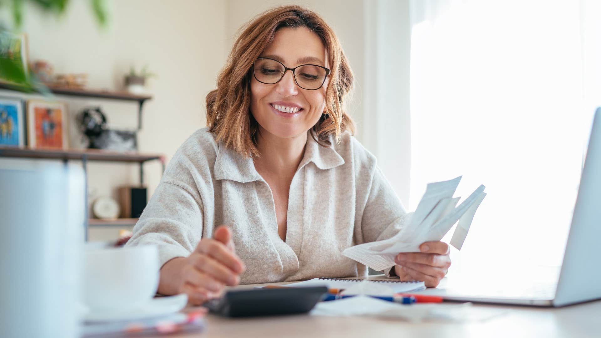Woman smiling and living below their means.