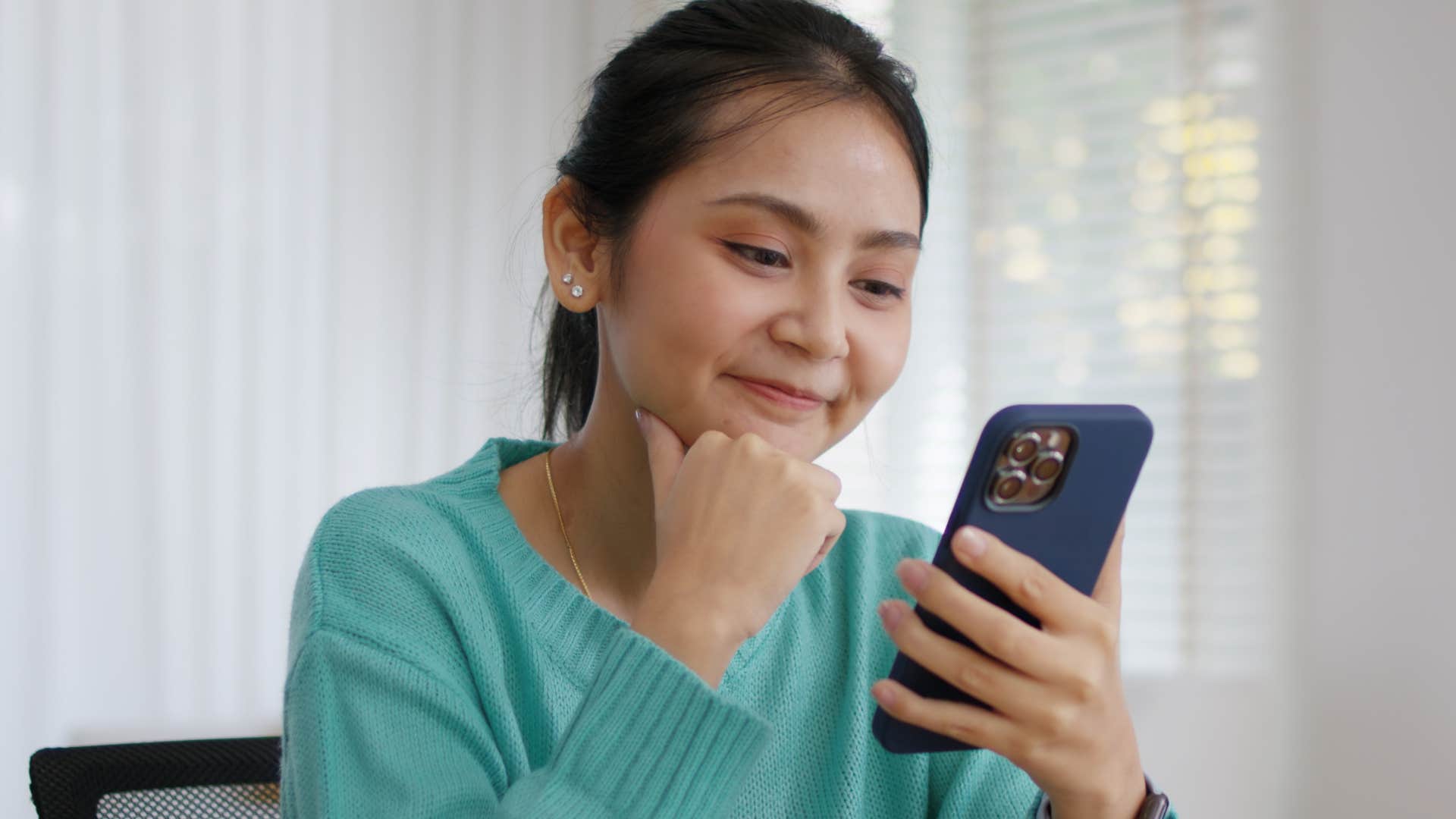 Woman smiling and waiting before making a purchase.