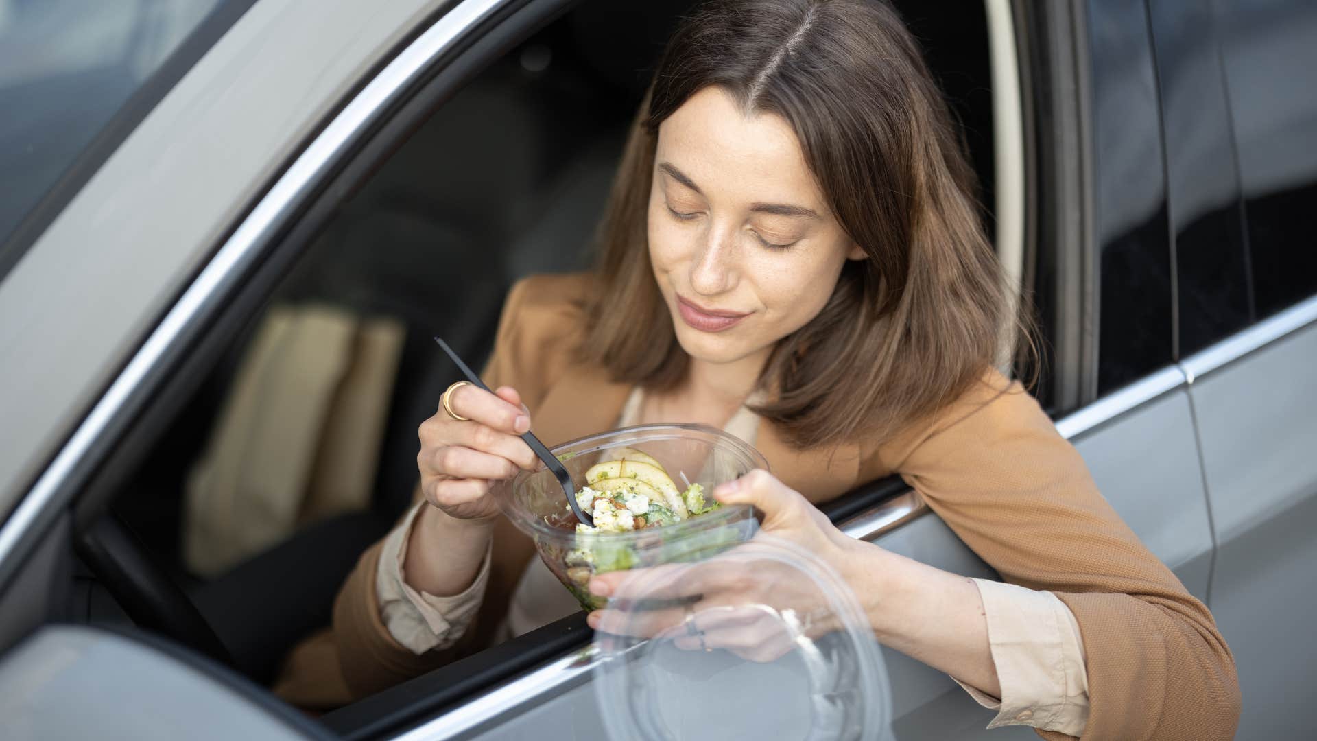 woman who is eating in her car