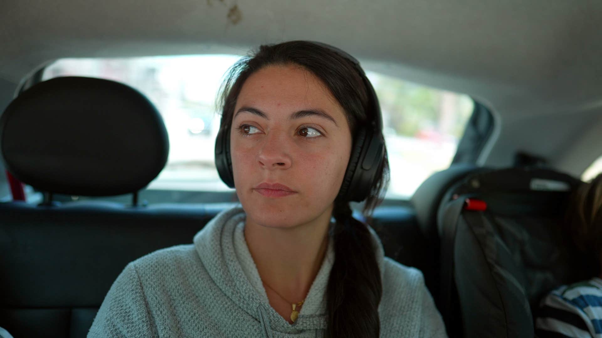 girl who is uncomfortable because there's a stranger in the car