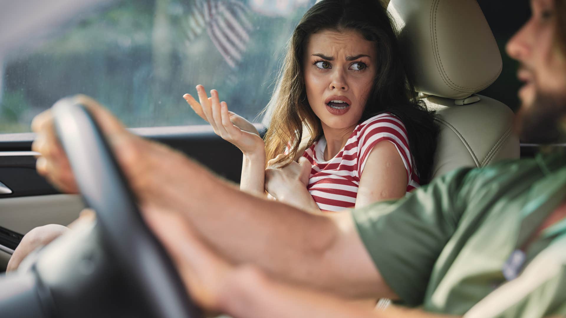 woman who isn't comfortable with loud music playing in her friend's car