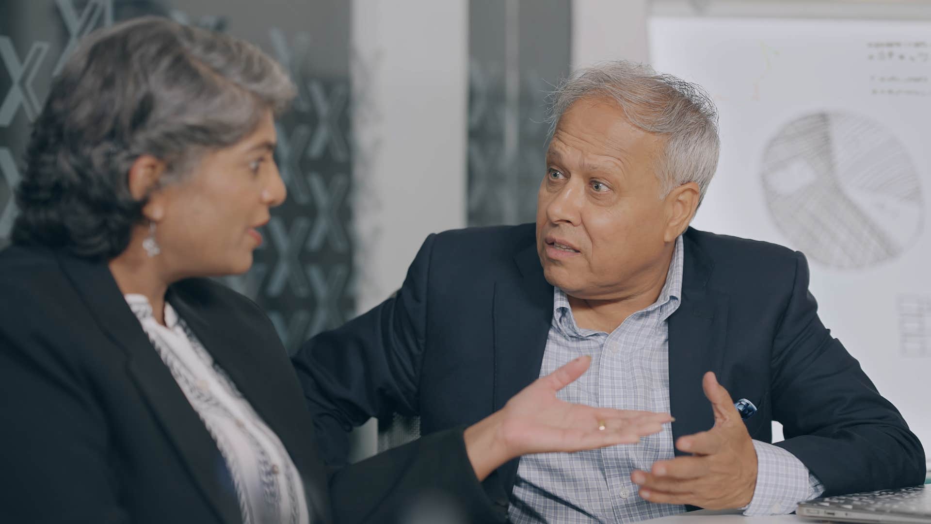 Two co-workers arguing about entitlement in a meeting.
