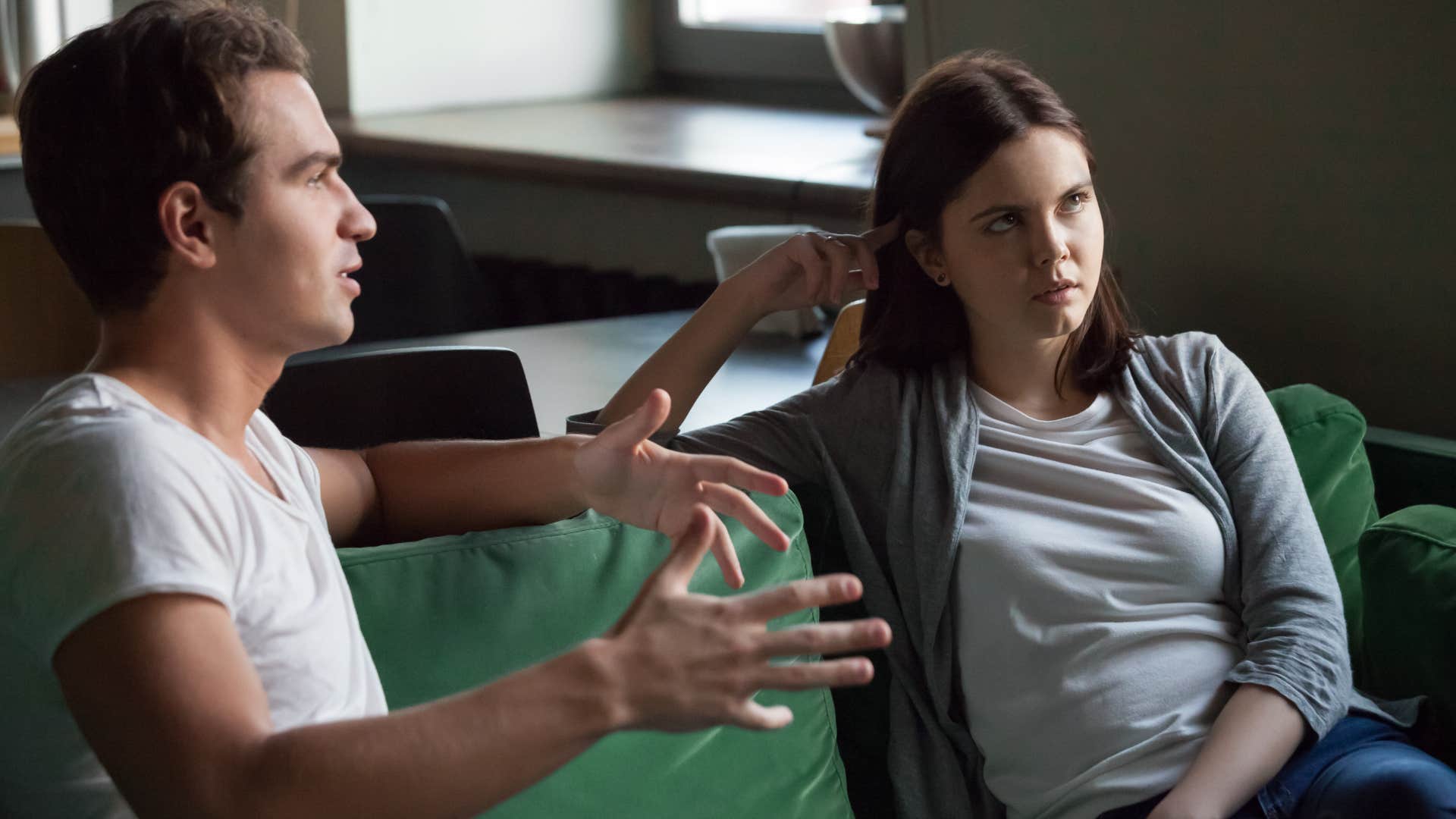 intelligent woman rolling her eyes as man talks about things he doesnt understand