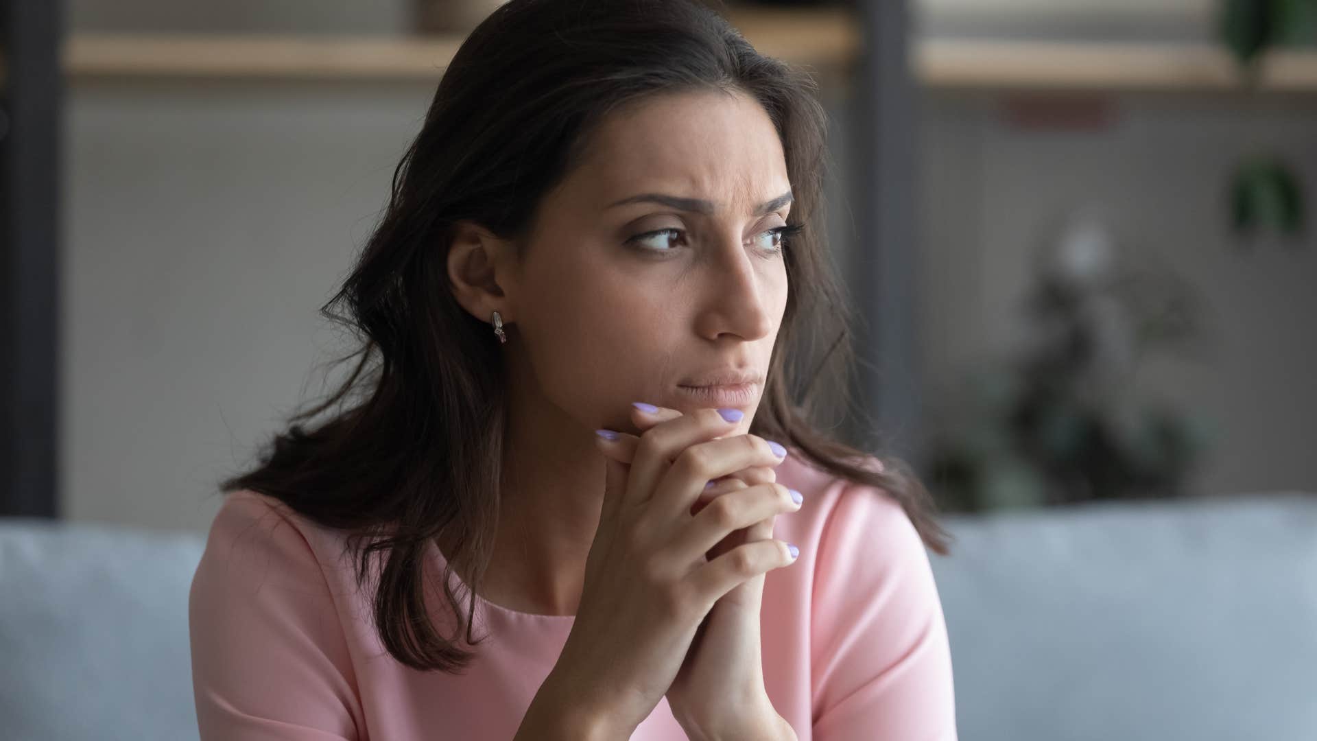 woman lacking self-worth looking out a window