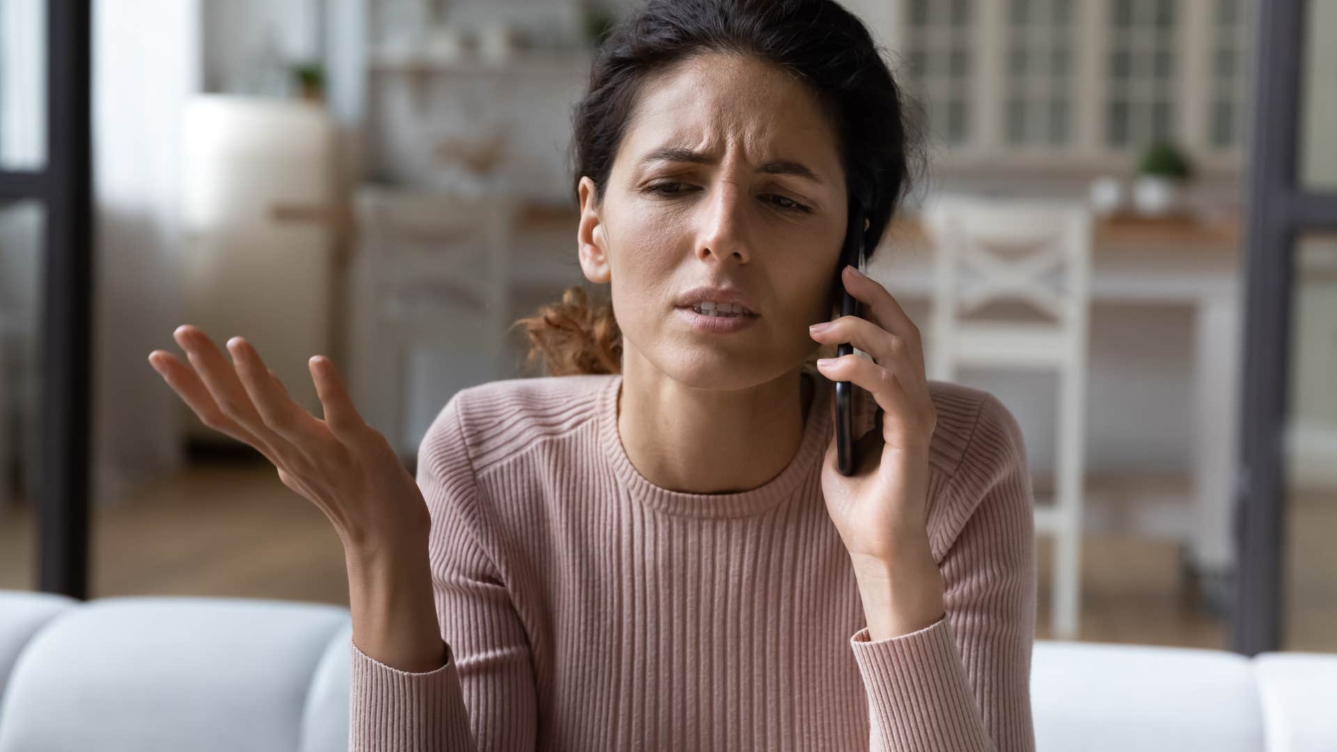 woman avoiding taking accountability talking on the phone