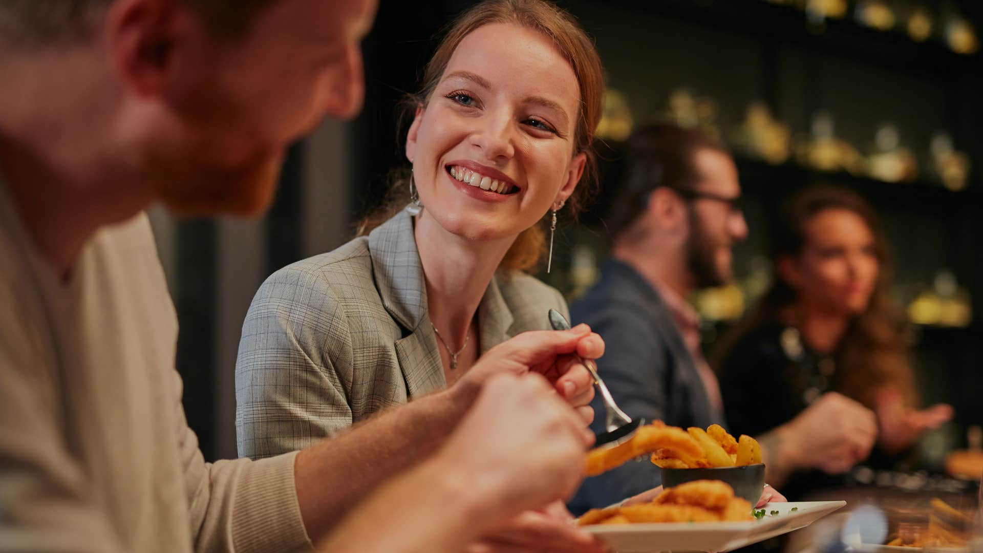 woman eating and wasting food at a restaurant