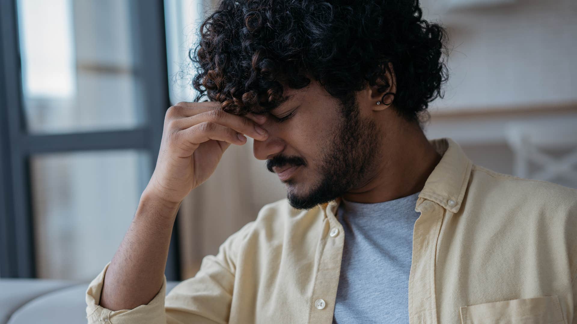 man experiencing decision paralysis looking stressed