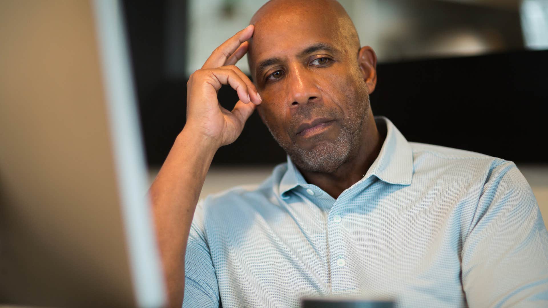 stressed man thinking about meeting expectations holding his head