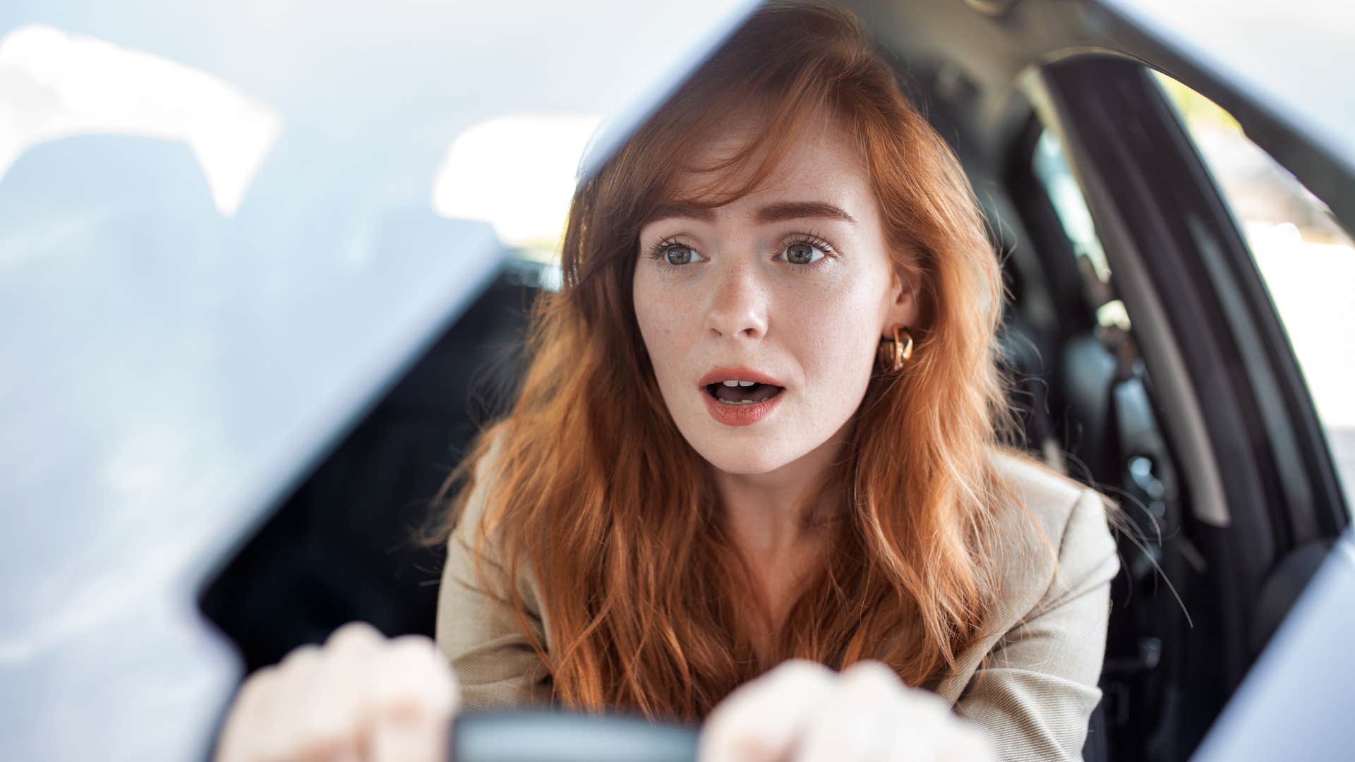 gen x woman driving car without a seat belt