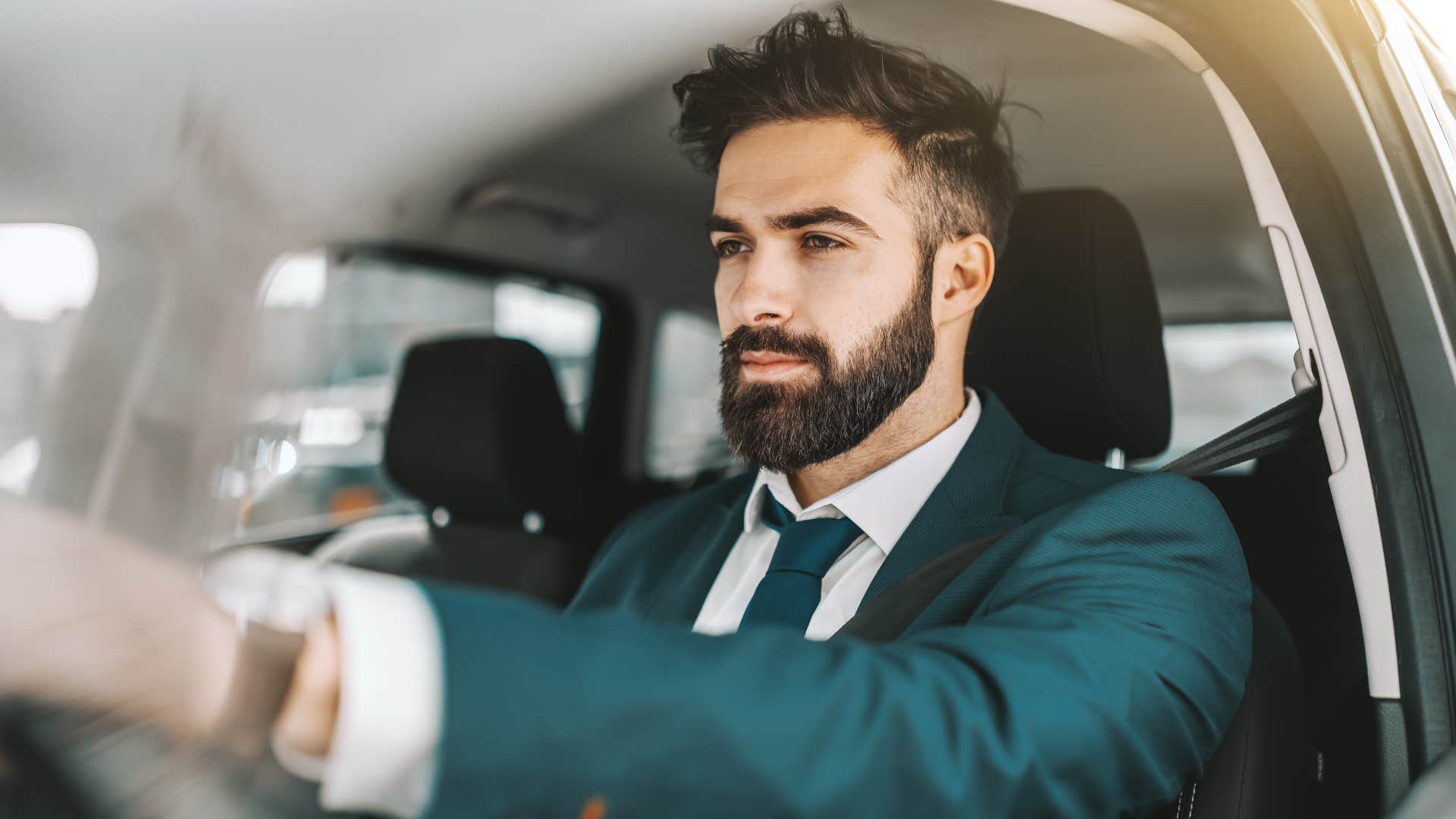 gen x man driving stick shift in the car