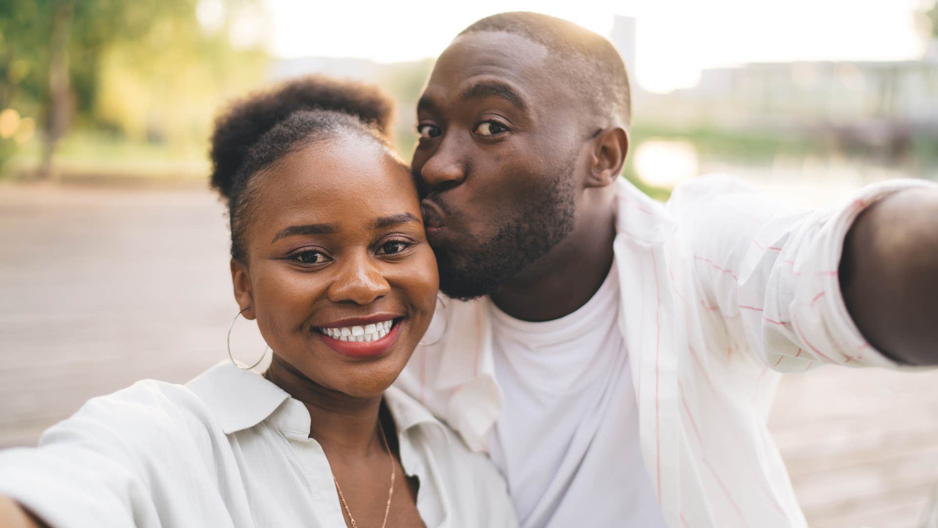 man kissing womans head being physically affectionate