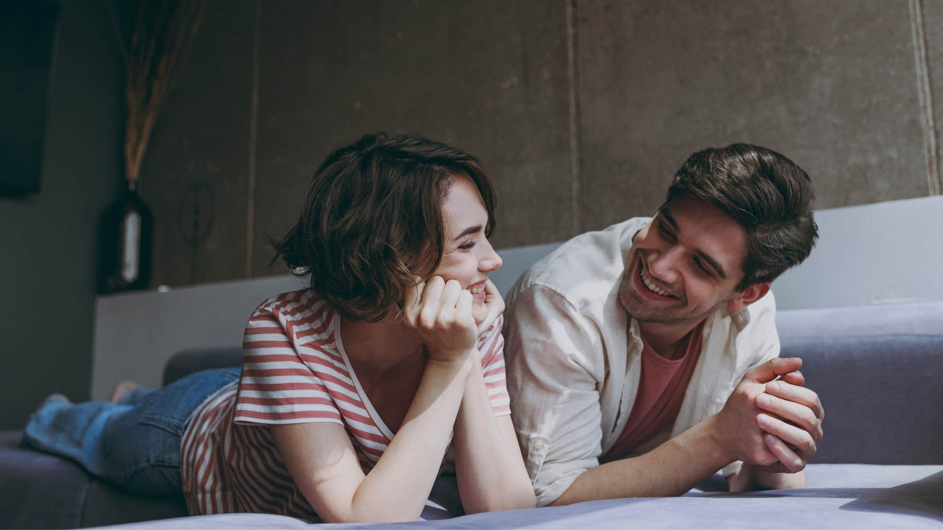 couple who fully trusts each other sitting on a bed