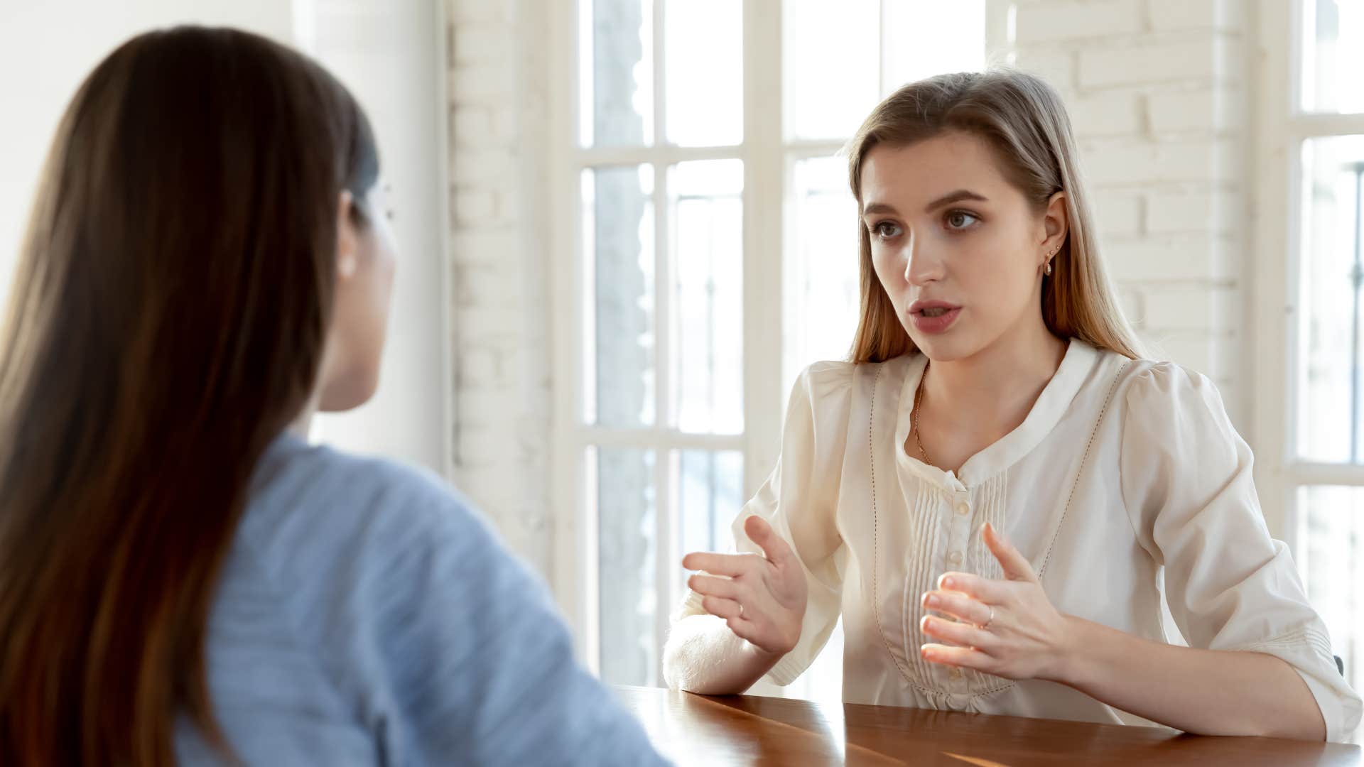 woman telling her friend to not wear formal attire to a casual event