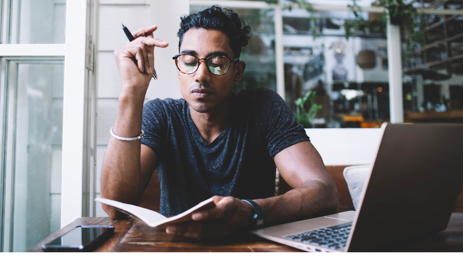 Man drafts handwritten letter