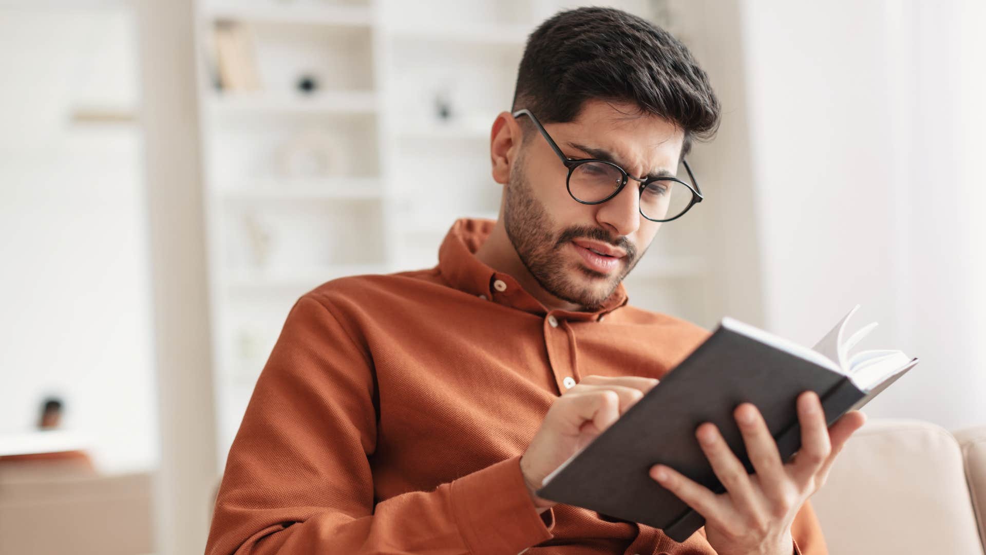 Man writes in planner