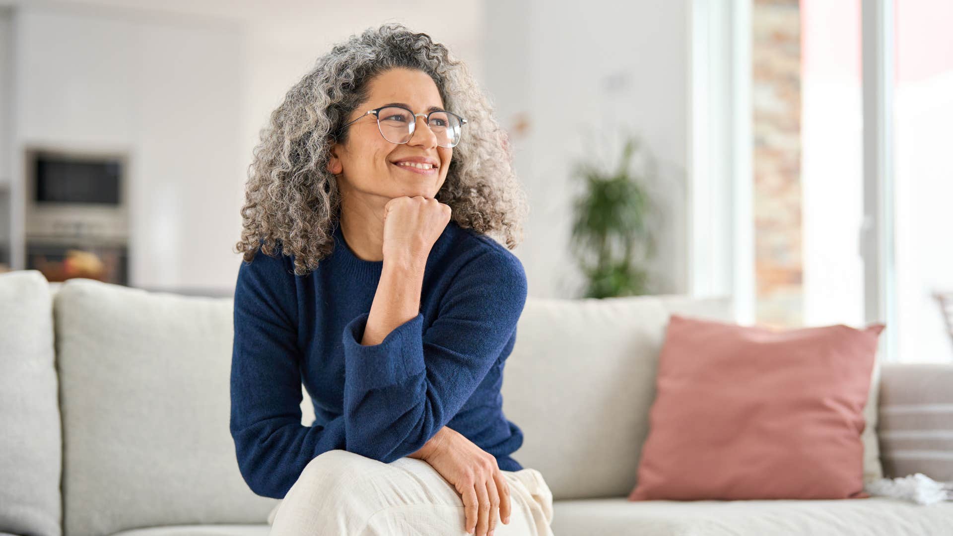 a woman looks at the furniture layout in her friends home and is impressed